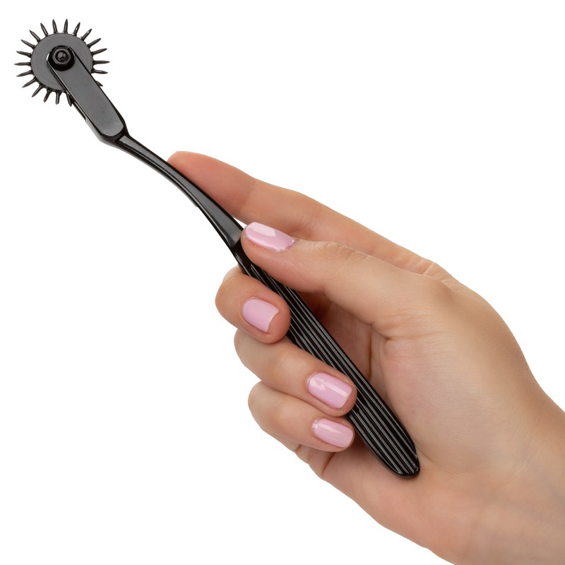 Boundless Sensory Pinwheel Stimulator product image Ergonomic handle of the single row Boundless pleasure wheel held in hand to show scale.
