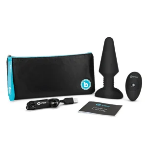 b-Vibe Vibrating Rimming Plug XL Black product image Unboxing layout showing the Rimming Plug XL, wireless remote control, USB charging cable, and storage bag.