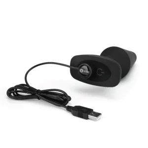 b-Vibe Vibrating Rimming Plug XL Black product image The b-Vibe Vibrating Rimming Plug XL connected to its magnetic USB charging cable.