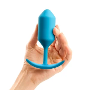 b-Vibe Snug Plug 3 - Weighted Silicone Butt Plug product image A hand holding the b-Vibe Snug Plug 3 to demonstrate its size, weight, and ergonomic design.