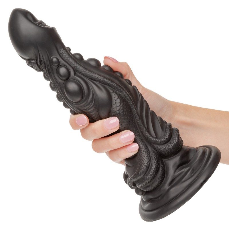 monster dong the colossus giant dildo held in hand demonstrating realistic large scale