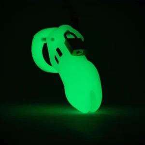 CB-6000 glow-in-the-dark chastity cage glowing vividly green in low light